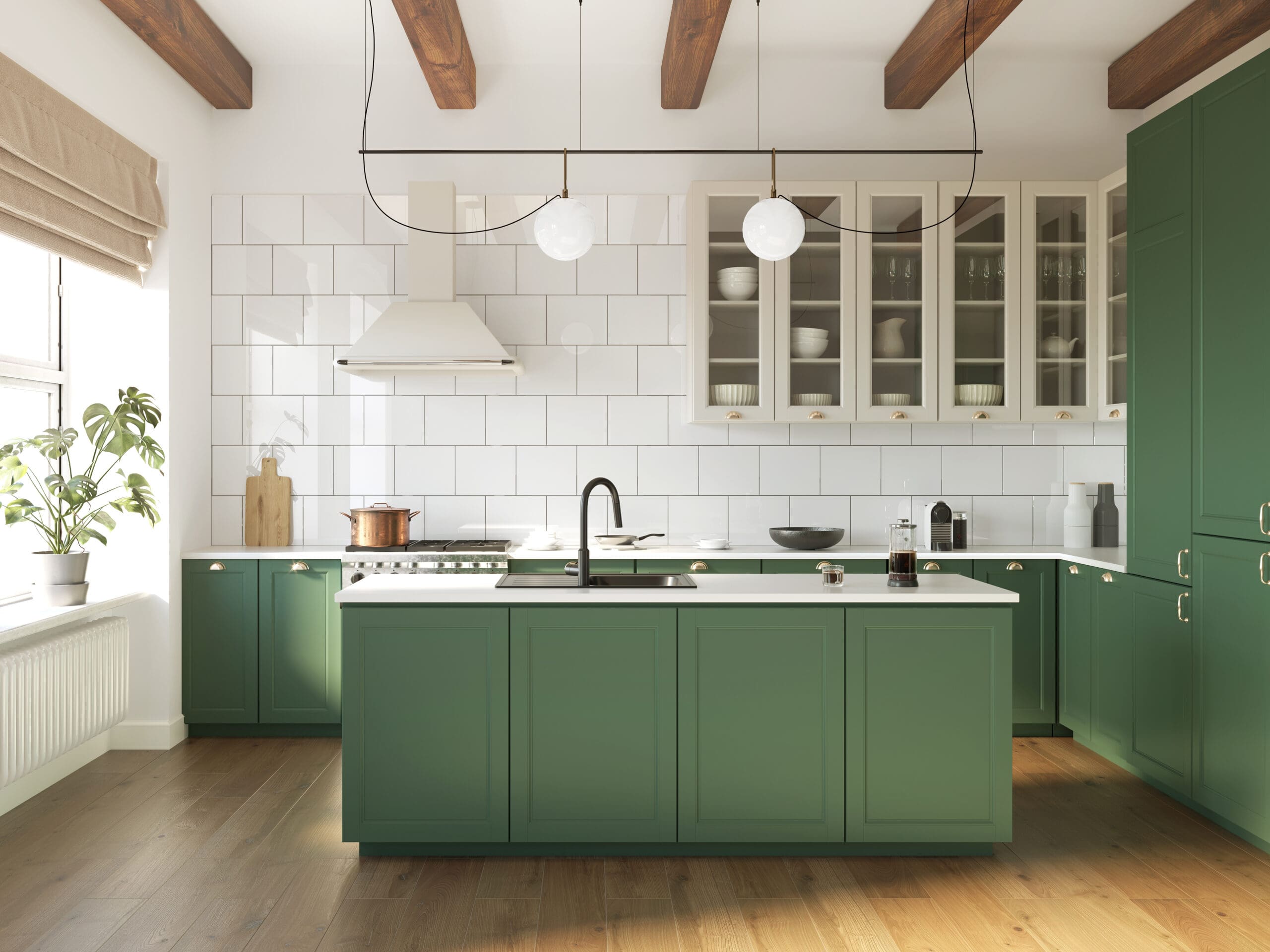 A modern kitchen with green cabinets, a white tile backsplash, and wooden ceiling beams. It features a large island with a black faucet, hanging globe lights, and a potted plant on the windowsill. Brown wood floors complement the decor.